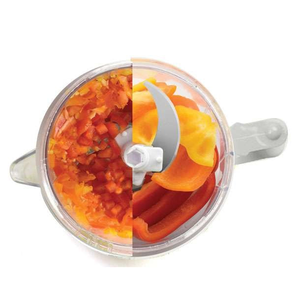 top view of mini food processor with half diced peppers and half whole peppers