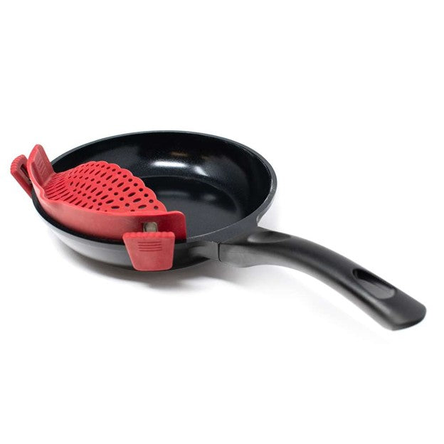 side view of red clip on pan strainer for draining food on black stainless pan