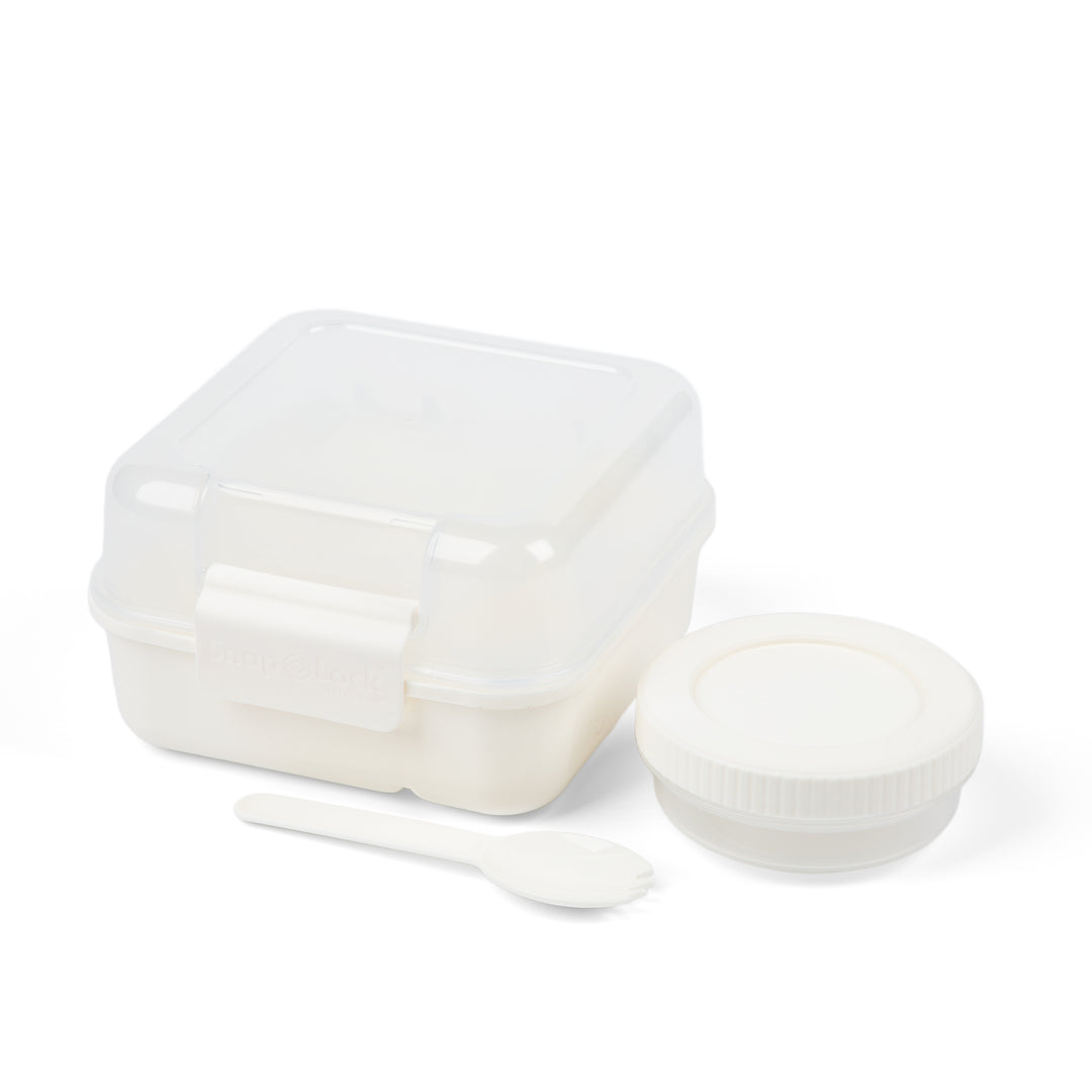 white plastic food containers for lunch box including a salad dressing container and matching spork