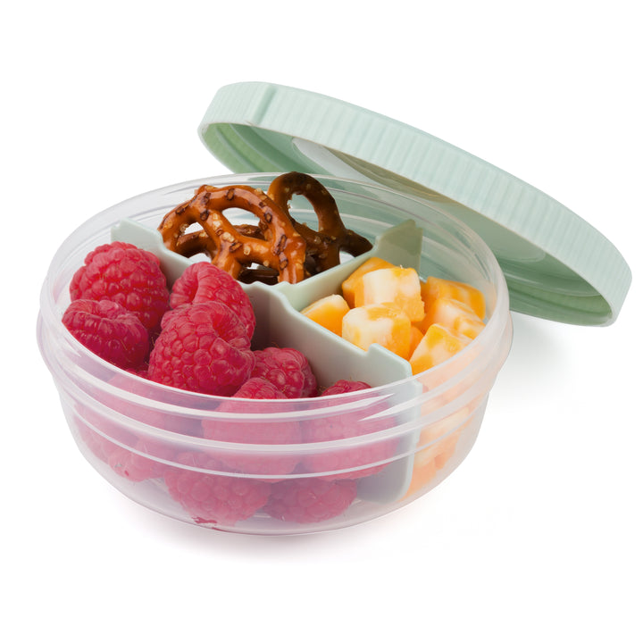 small plastic food storage container for snack storage in mint color with lid on the side revealing snacks, including raspberries, cheese cubes, and pretzels