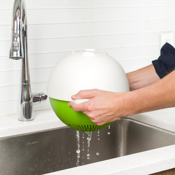 colander straining food with plastic bowl cover in kitchen