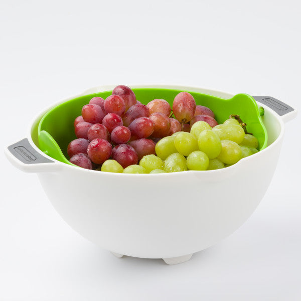 kitchen colander strainer with red and green grapes