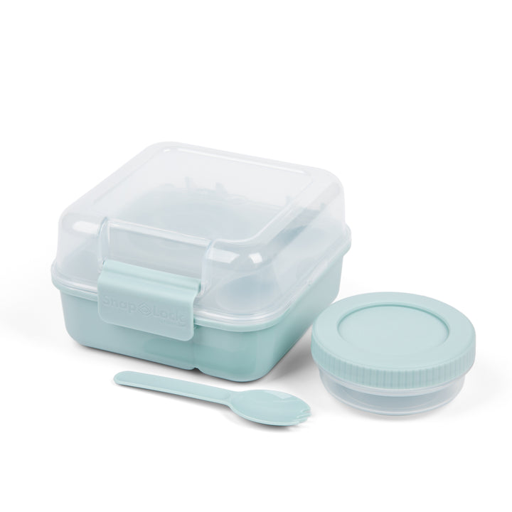 light blue plastic food storage container for lunch with matching salad dressing cup and spork