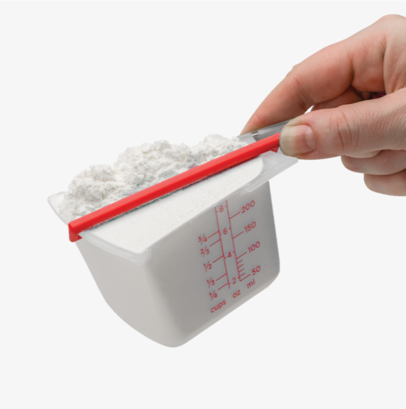 plastic kitchen measuring cup with flour