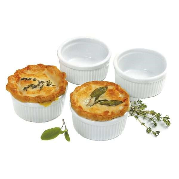 four white porcelain dishes with two potpies and two empty