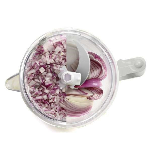 top view of small food blender chopper with half onion pieces and half diced onions