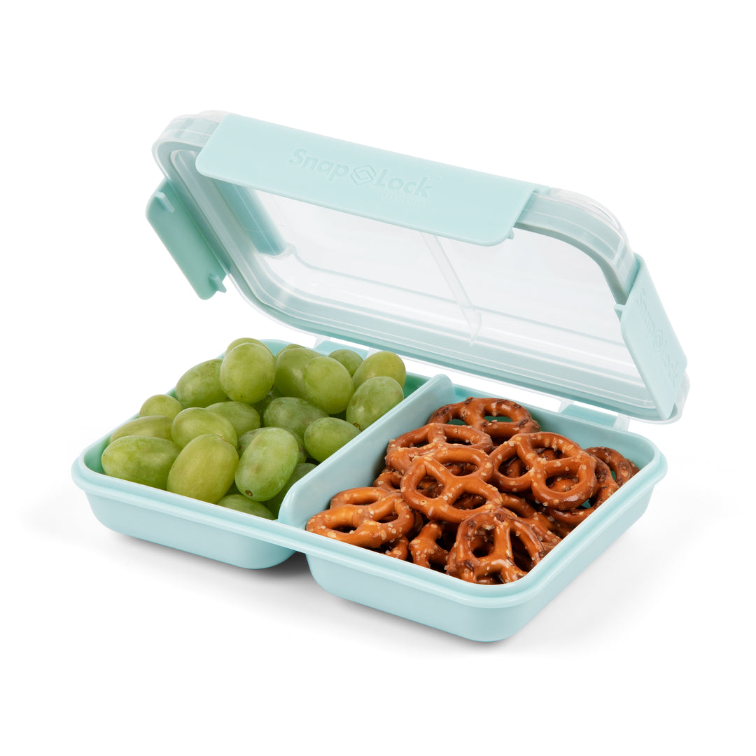 light blue plastic lunch box container with open lid and divider separating green grapes and pretzels