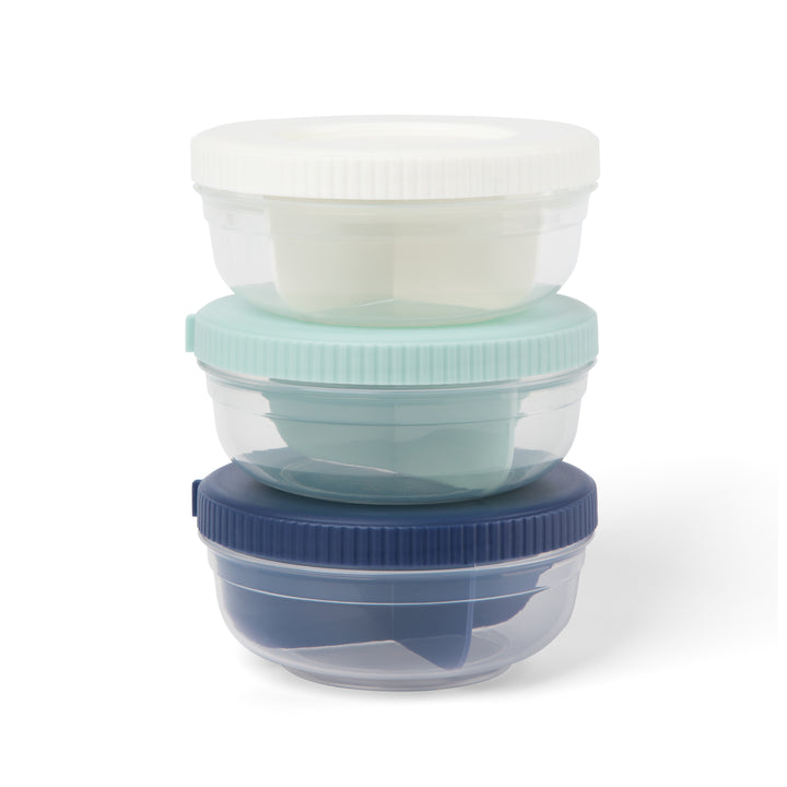 three plastic stackable food storage snack containers stacked on top of each other, in navy, mint, and white colors