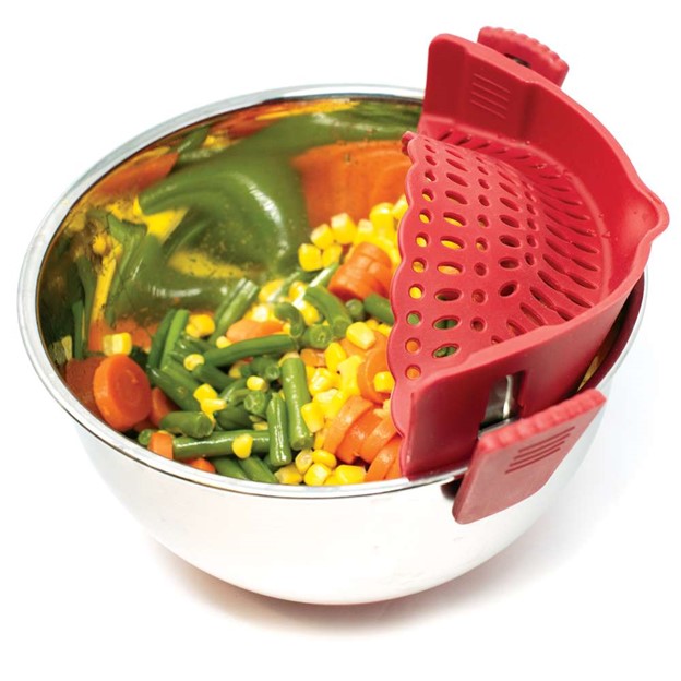 side view of red silicone clip on strainer attached to silver bowl with cooked mixed vegetables 