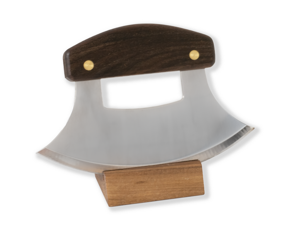 Ulu Mezzaluna knife with walnut handle sitting in walnut wood stand